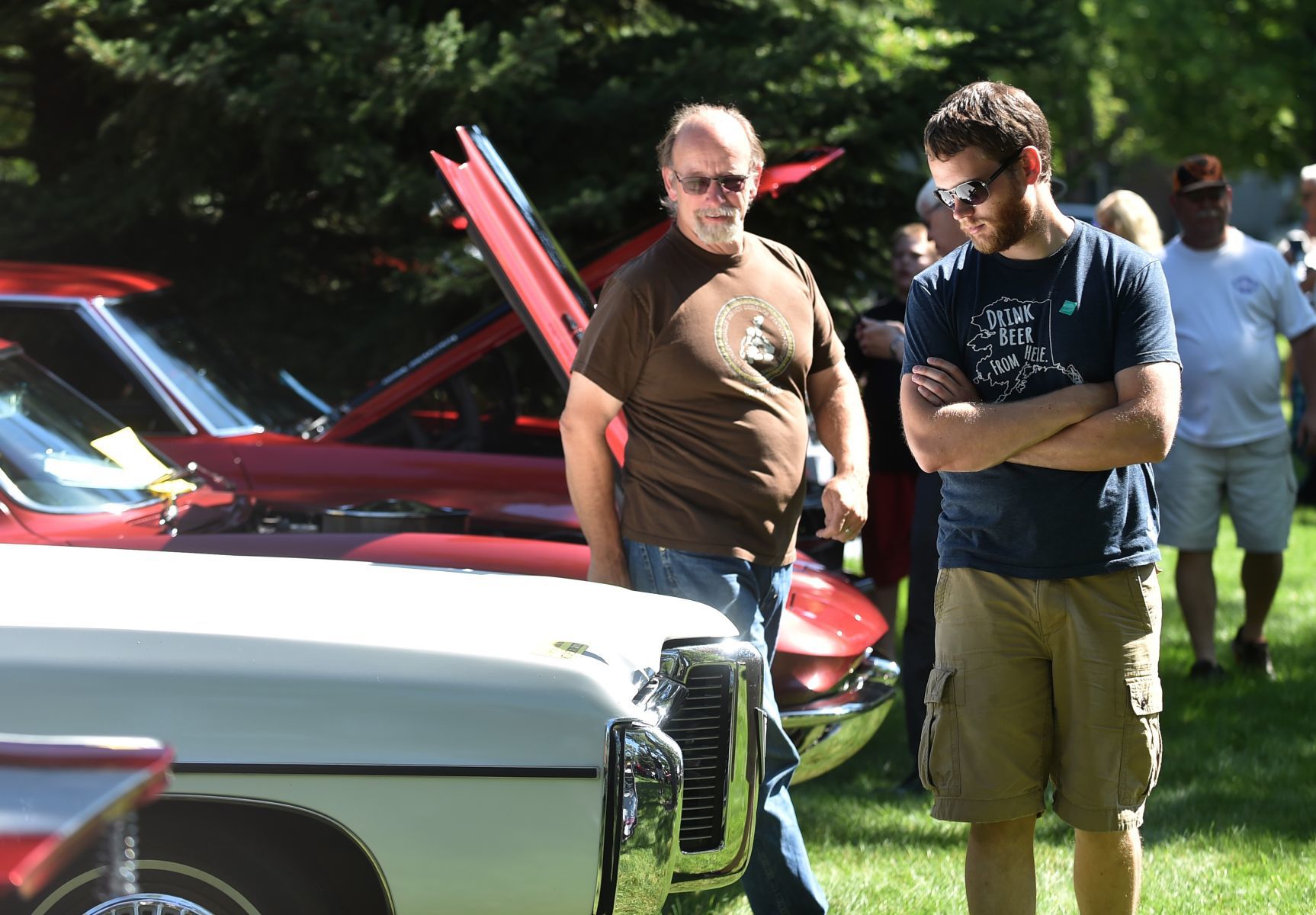 Andrew and Arvid Koval look at cars